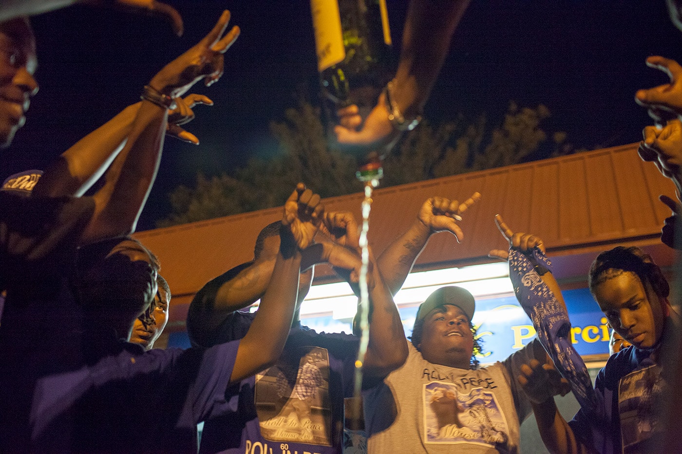 Young men who identify as Crips gather in a circle and spill liquor to mourn Maurice Streeter, who was shot and killed in April 2013.