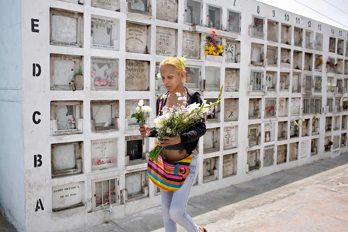 Nearly every week, Yasuri visits the Baquijano Cemetery to leave flowers and pray at a Peruvian saint's tomb.